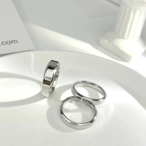 Macro view of minimalist polished silver stainless steel rings with beveled edges