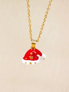 Detail of gold Christmas hat pendant with red enamel, snowflakes, and zircon stone