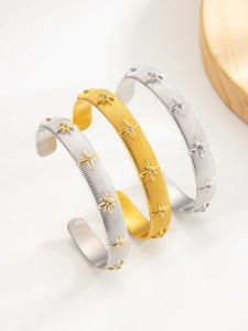 Macro view of North Star bracelets in gold and silver with zircon star pattern