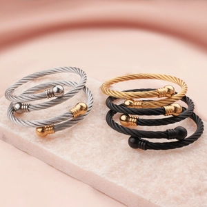 Adjustable stainless steel twisted cable bangles in silver, gold, and black finishes