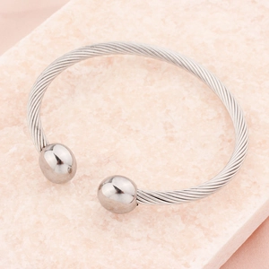 Elegant silver stainless steel twisted cable cuff bracelet with round metal ball ends