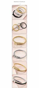 Macro detail of industrial punk wire bracelets in gold, silver, and black finishes