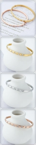 Detailed view of minimalist 18K gold and silver bangles set with sparkling cubic zirconia