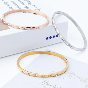Three minimalist stackable titanium steel bangles with sparkling round zircon stones