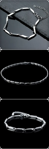 Close-up of a polished stainless steel bamboo link chain with a lobster clasp