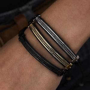 Close-up of three men's braided bracelets with micro-pave black zircon metal bars