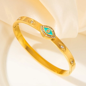 Golden stainless steel evil eye bangle with blue enamel and sparkling crystal stones