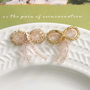 Close-up of pink crystal beaded bow with shimmering rhinestones and tassel details