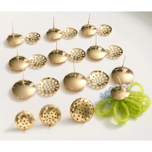 Macro shot of gold-plated stud earring bases and DIY jewelry findings for earring making