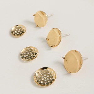 Detail of gold-plated stud earring bases with prongs and perforated mesh for DIY jewelry