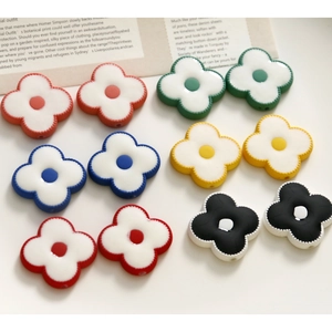 Flat lay of colorful acrylic flower beads for DIY jewelry making with smooth glazed finish