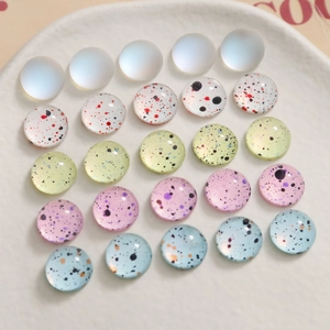 Polished 10mm glass cabochons with colorful ink splatter patterns for DIY jewelry making