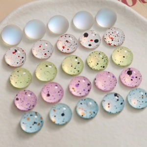 Detailed view of 10mm colorful ink splatter glass beads for DIY crafts and jewelry