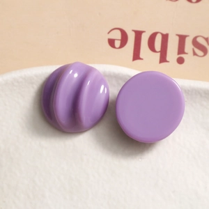 Macro view of chic purple resin stud earrings featuring smooth and wavy textured surfaces