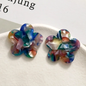 Macro shot of colorful floral acetate flower charms for DIY jewelry making and crafts