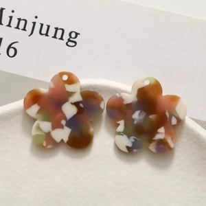 Macro detail of multi-colored marble acetate flower pendants for DIY jewelry making