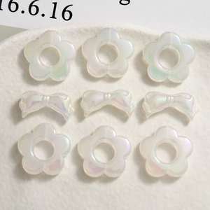Iridescent matte resin flower and bow charms with a pearlescent finish for DIY jewelry