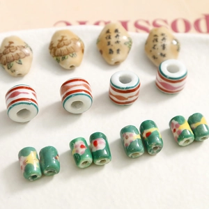 Macro view of handmade ceramic beads with vintage Chinese calligraphy and floral patterns