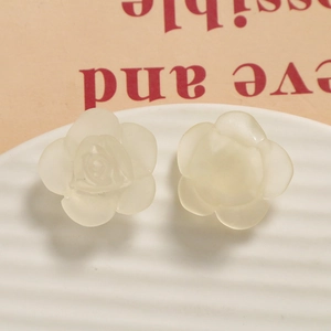 Detail of cream matte resin rose flower accessories with translucent layered petals