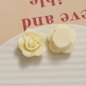 Macro detail of cream resin rose flower charms for DIY jewelry and crafts making