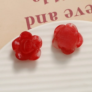 Detailed macro view of resin rose charms with gradient petals for DIY jewelry making