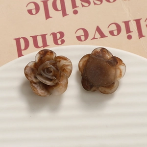 Detail showing brown marble texture on rose flower resin charm with front and back views