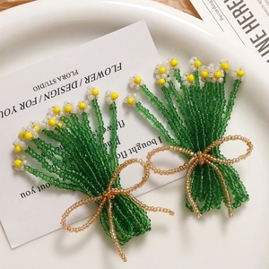 Handmade woven glass bead earrings with rice flower and bowknot in pastoral style
