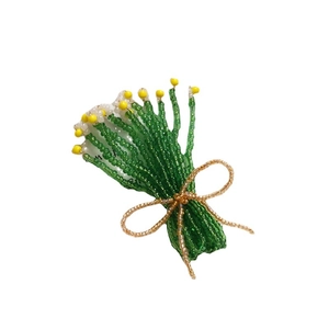 Handmade beaded floral brooch with green stems, white flowers and golden bow decoration