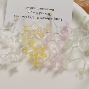 Macro view of transparent bellflower glass beads with gold rings for DIY jewelry