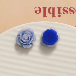 Detailed macro view of sky blue resin rose petals and flat back base for DIY crafts