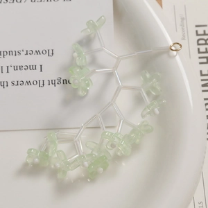 Macro detail of translucent light green bellflower beads for DIY jewelry making accessories
