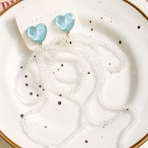 Elegant long tassel beaded earrings with blue heart and clear crystals on display card