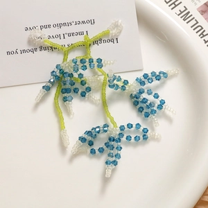 Handcrafted woven blue crystal flower cluster earrings in a forest style design