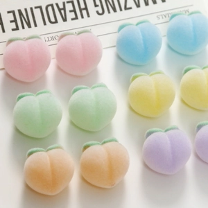 Flat lay of colorful 3D peach charms with soft flocking texture for DIY jewelry crafts