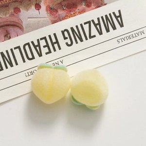 Close-up of fluffy peach resin charms with yellow flocking texture for DIY jewelry making