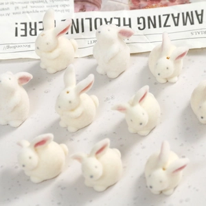 Macro shot of white flocked 3D bunny resin accessories for DIY jewelry making and crafts