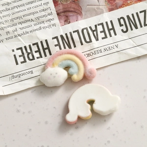 Detailed macro view of colorful flocked rainbow cloud resin charms with flat white backing