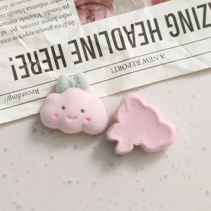 Detail of pink flocked cloud charms with cute smile and soft texture for DIY jewelry making