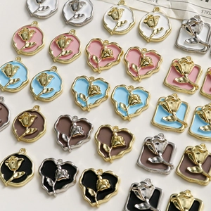 Flat lay of alloy rose charms in various shapes and colors for DIY jewelry making