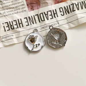 Detailed close-up of rose relief pendants with vintage oil drip design for DIY jewelry