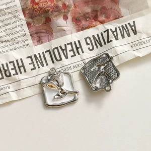 Detailed macro view of square rose charms with white enamel petals for DIY jewelry making