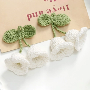 Handmade crochet lily of the valley flowers with green leaves in soft cotton yarn