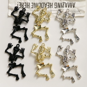 Detailed view of skull charms in matte black, gold, and silver for DIY jewelry