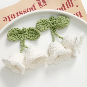 Handmade crochet Lily of the Valley floral pendant with white bell petals and green leaves