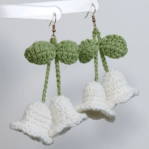 Handmade crochet lily of the valley earrings with white bell flowers and green leaves