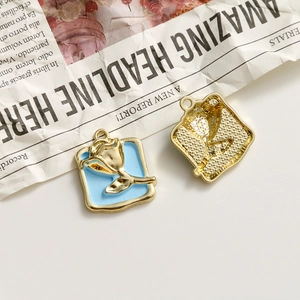 Detail of blue enamel heart pendant with golden 3D rose and back matte texture