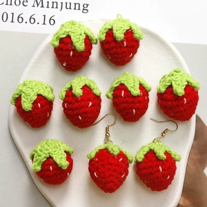 Handmade knitted strawberry charms and earrings set with green leaf details and hooks