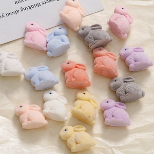 Detailed view of colorful flocked resin bunny charms for DIY jewelry and hair accessories