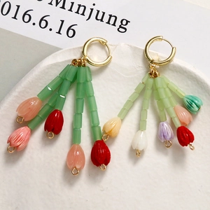 Pastel tulip-shaped beaded dangle earrings with golden hoops and colorful flower petals