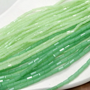 Macro detail of faceted green beads in light and emerald tones for DIY jewelry